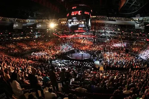 UFC fighters grappling inside the octagon — live event
